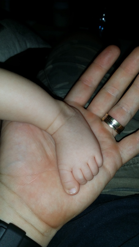 Baby's foot, Dad's hand